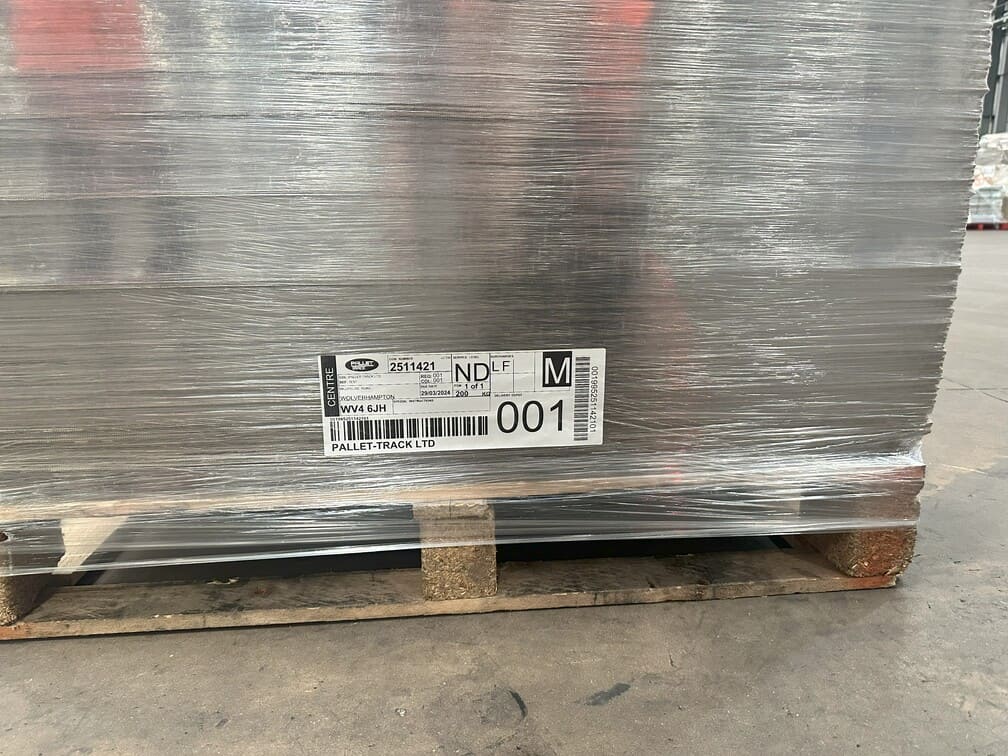 A correctly labelled pallet with label positioned at the bottom of the pallet, on a flat surface